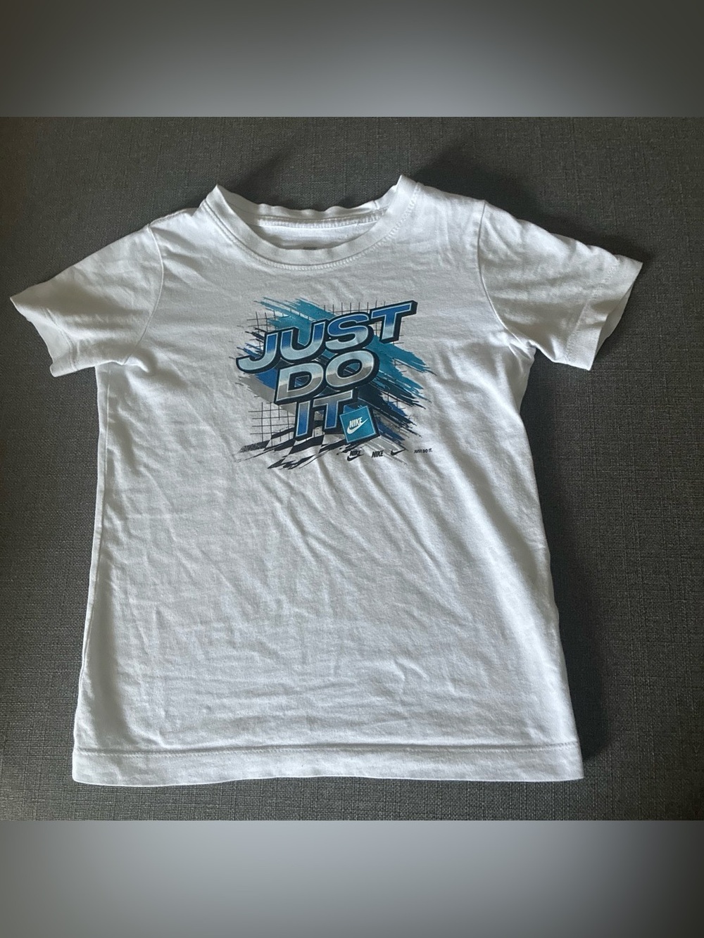 Nike Kids White Tee with Blue 'Just Do It' Graphic